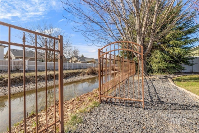 view of yard featuring a water view and fence