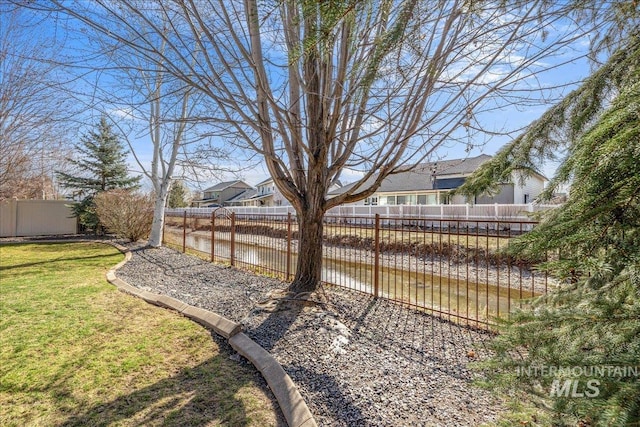 view of yard featuring a residential view and a fenced backyard