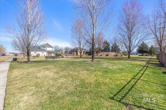 view of yard with playground community and fence