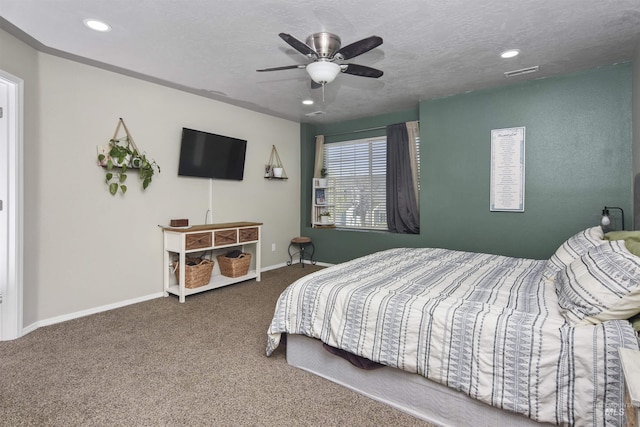 bedroom featuring ceiling fan, a textured ceiling, and carpet