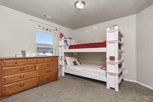 bedroom featuring a textured ceiling and carpet