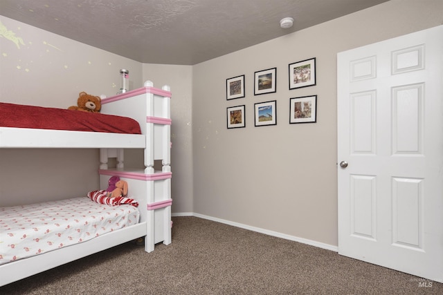 bedroom featuring carpet flooring and a textured ceiling