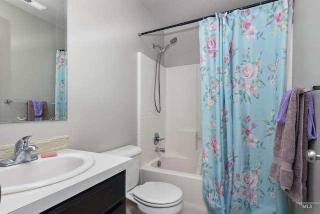 full bathroom featuring vanity, shower / tub combo, and toilet