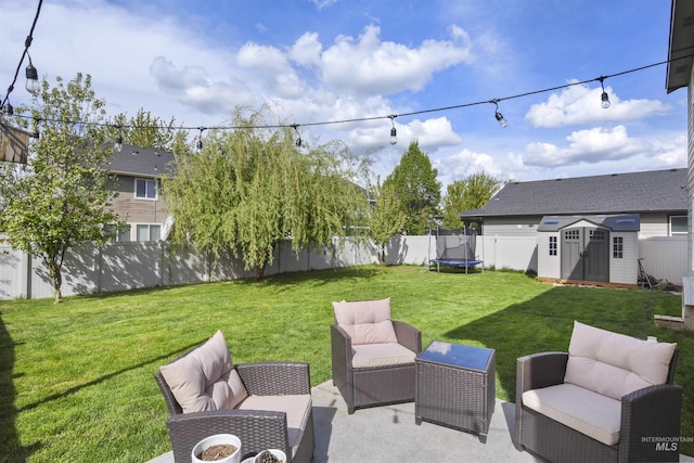 view of yard with outdoor lounge area and a storage unit