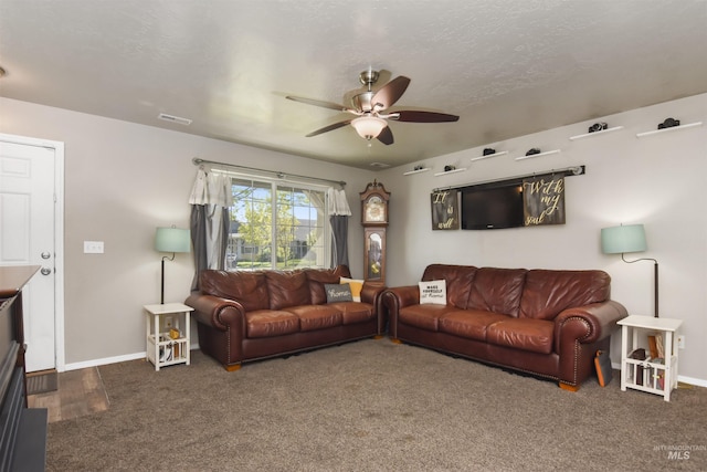 living room with dark carpet, a textured ceiling, and ceiling fan