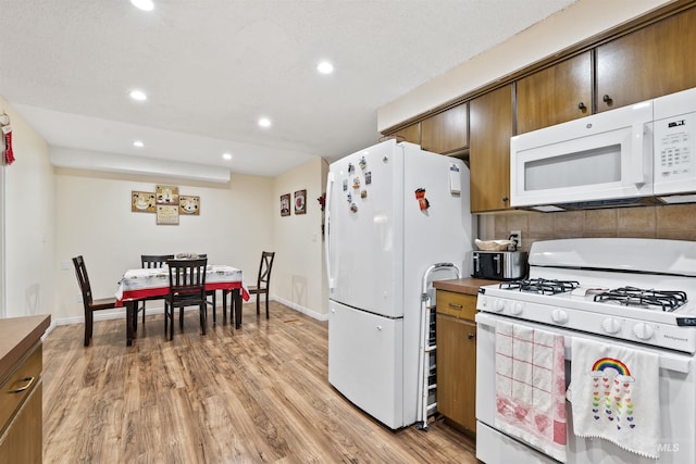 kitchen featuring white appliances and light wood-type flooring