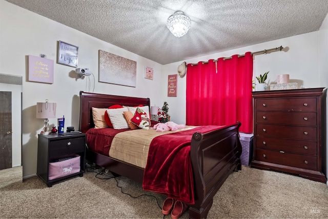 bedroom featuring a textured ceiling and light carpet