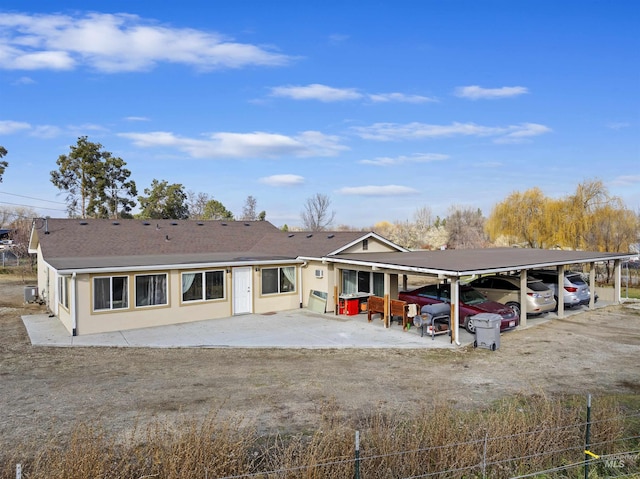 view of front of home featuring central AC and a carport