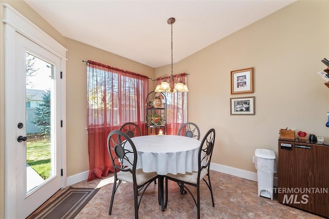 dining space with plenty of natural light, baseboards, and an inviting chandelier