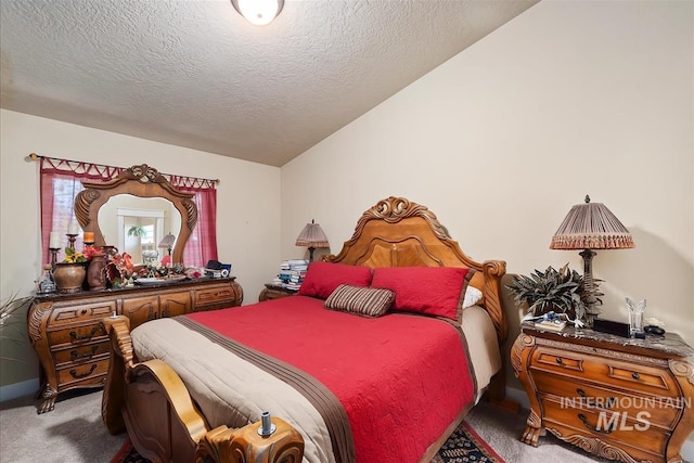 carpeted bedroom featuring vaulted ceiling and a textured ceiling