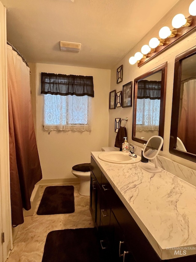 bathroom featuring vanity and toilet