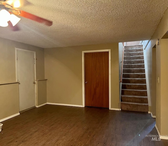 unfurnished room with dark hardwood / wood-style floors, a textured ceiling, and ceiling fan