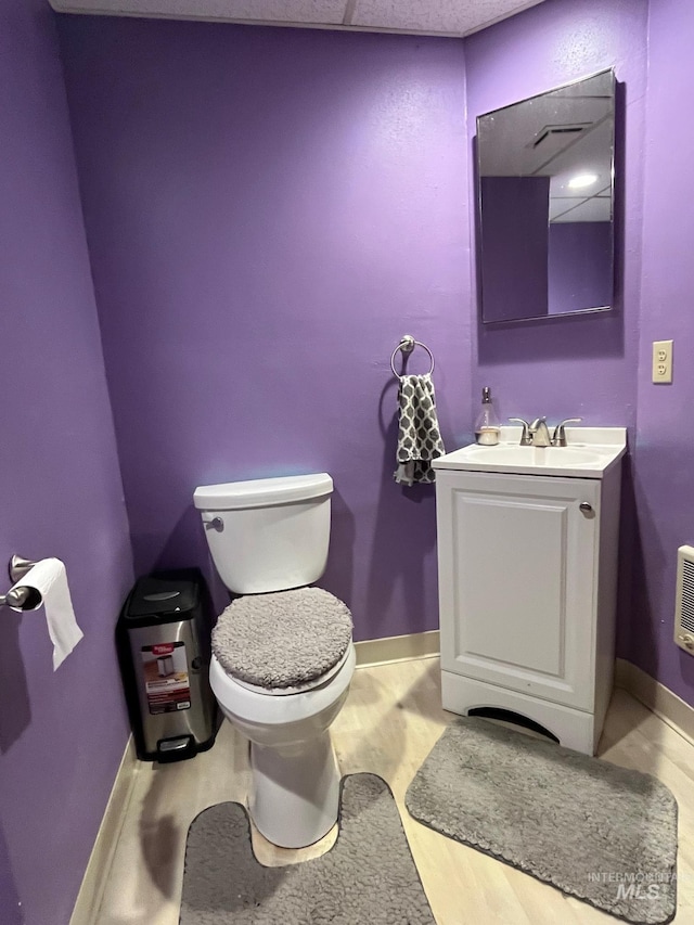 bathroom with vanity, wood-type flooring, and toilet