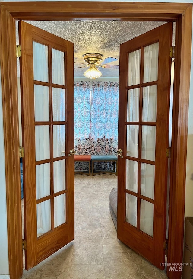 doorway to outside featuring french doors and ceiling fan