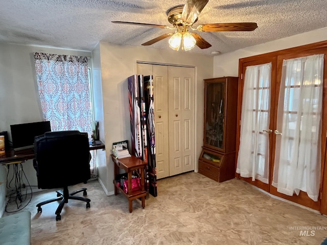 home office featuring ceiling fan, french doors, and a textured ceiling