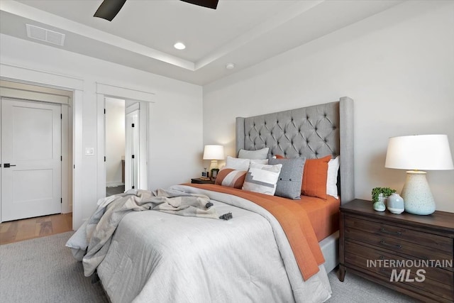 bedroom with wood finished floors, recessed lighting, visible vents, and ceiling fan