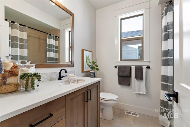 full bathroom with tile patterned floors, visible vents, toilet, baseboards, and vanity