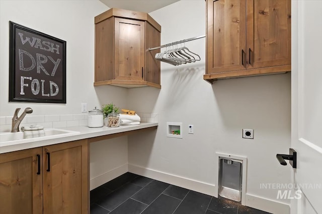 laundry area featuring baseboards, washer hookup, cabinet space, hookup for an electric dryer, and a sink