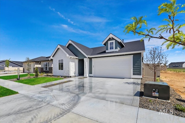 view of front of home featuring driveway, an attached garage, and a front yard