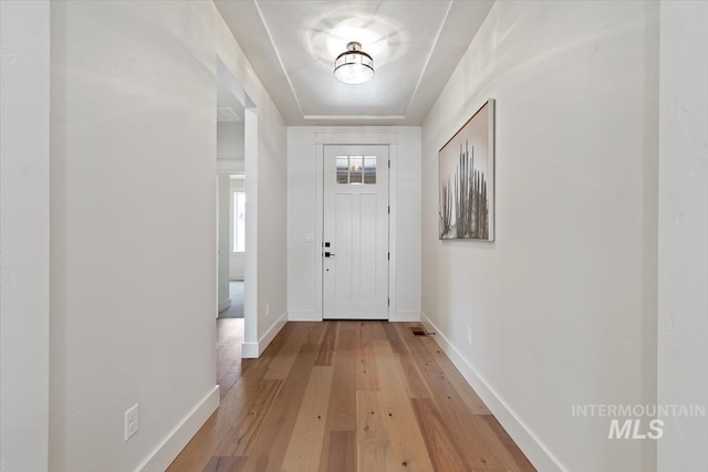 entrance foyer with light wood-type flooring and baseboards