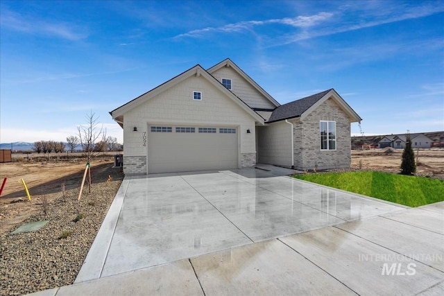 view of front of home with brick siding, an attached garage, and driveway