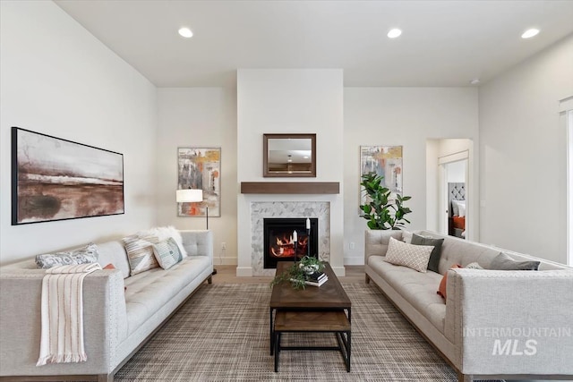 living area with recessed lighting, baseboards, and a premium fireplace