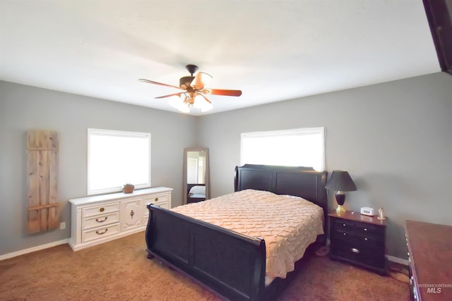 carpeted bedroom with multiple windows and ceiling fan
