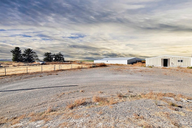 view of yard with an outdoor structure and a rural view