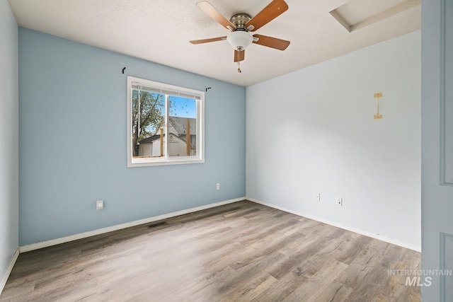 511 Bitterbrush Ave, Nampa, ID 83686 - empty room featuring wood finished floors, attic access, and baseboards