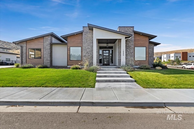 contemporary home with a front lawn