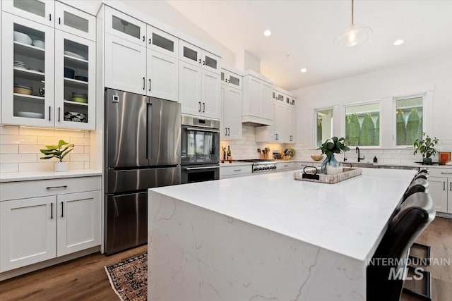 1889 W Winter Camp Ct, Boise, ID 83703 - kitchen with appliances with stainless steel finishes, tasteful backsplash, a center island, and recessed lighting