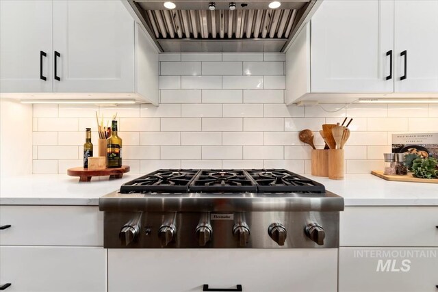 1889 W Winter Camp Ct, Boise, ID 83703 - kitchen view of stainless steel gas cooktop, premium range hood, light countertops, and white cabinets
