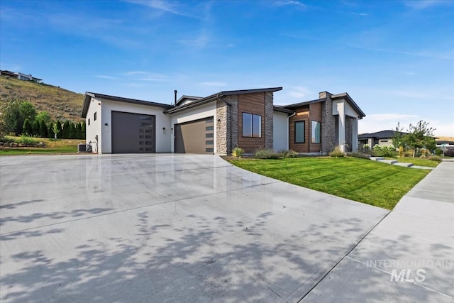 view of front of property with a front yard and a garage