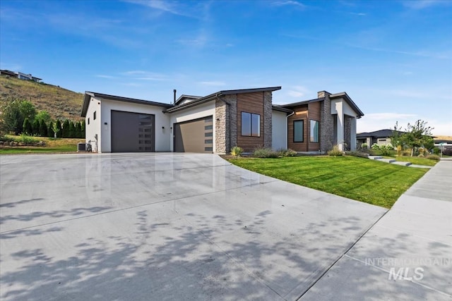 1889 W Winter Camp Ct, Boise, ID 83703 - contemporary house featuring an attached garage, a front lawn, driveway, stone siding, and stucco siding