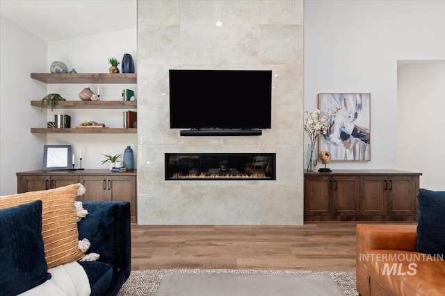 1889 W Winter Camp Ct, Boise, ID 83703 - living area featuring a tiled fireplace and light wood-style floors