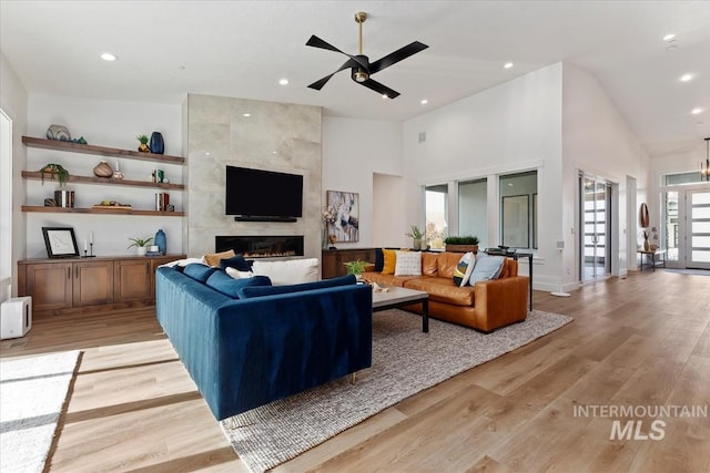 1889 W Winter Camp Ct, Boise, ID 83703 - living room featuring a ceiling fan, a fireplace, light wood-style flooring, high vaulted ceiling, and recessed lighting
