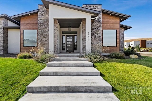 1889 W Winter Camp Ct, Boise, ID 83703 - view of exterior entry with a yard, stone siding, and stucco siding