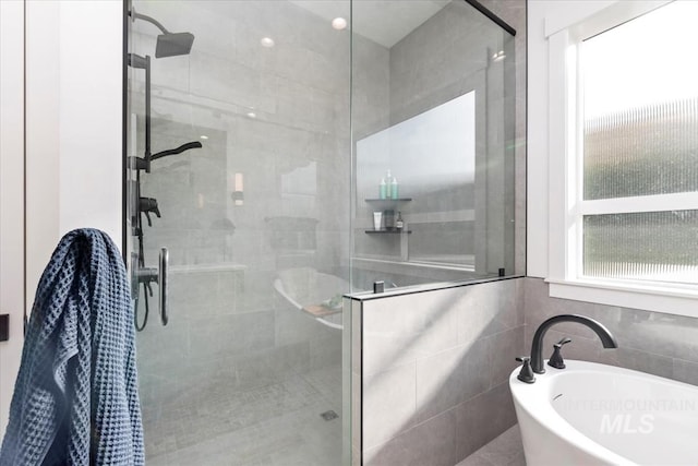 1889 W Winter Camp Ct, Boise, ID 83703 - full bathroom featuring a stall shower, a freestanding bath, healthy amount of natural light, and tile walls