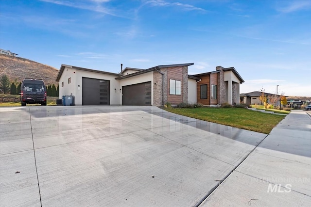 1889 W Winter Camp Ct, Boise, ID 83703 - view of front facade with a garage, a front lawn, driveway, stucco siding, and stone siding
