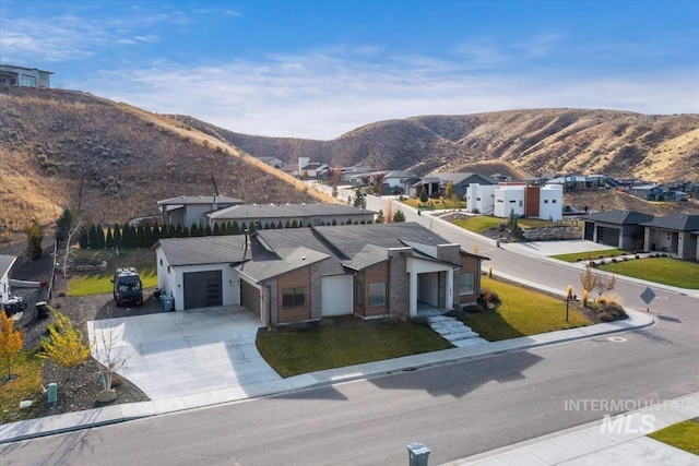 1889 W Winter Camp Ct, Boise, ID 83703 - view of front facade featuring a mountain view, concrete driveway, a residential view, and a garage