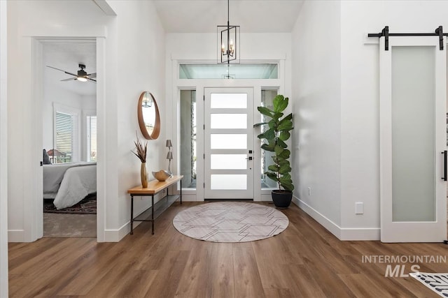 1889 W Winter Camp Ct, Boise, ID 83703 - foyer entrance with a barn door, baseboards, wood finished floors, and a ceiling fan