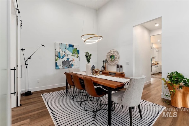 1889 W Winter Camp Ct, Boise, ID 83703 - dining area with wood finished floors, baseboards, a high ceiling, and recessed lighting
