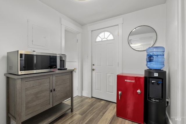 entryway with wood finished floors and electric panel
