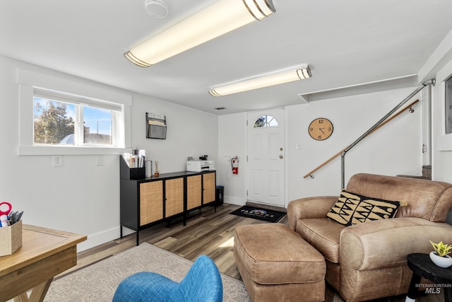 living area featuring baseboards and wood finished floors