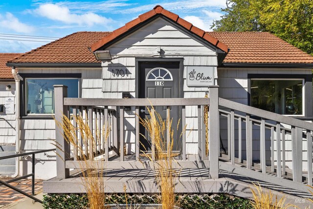 entrance to property with a tiled roof
