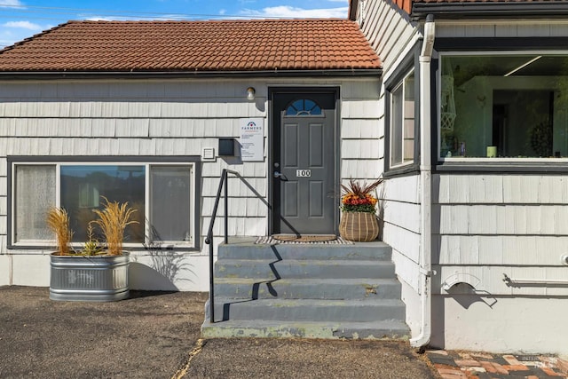 entrance to property with a tiled roof