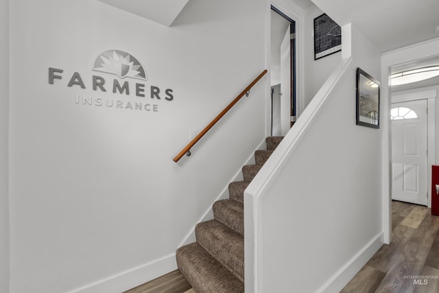 stairway with baseboards and wood finished floors