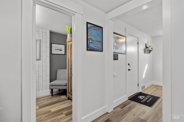 entrance foyer with visible vents, baseboards, and light wood finished floors