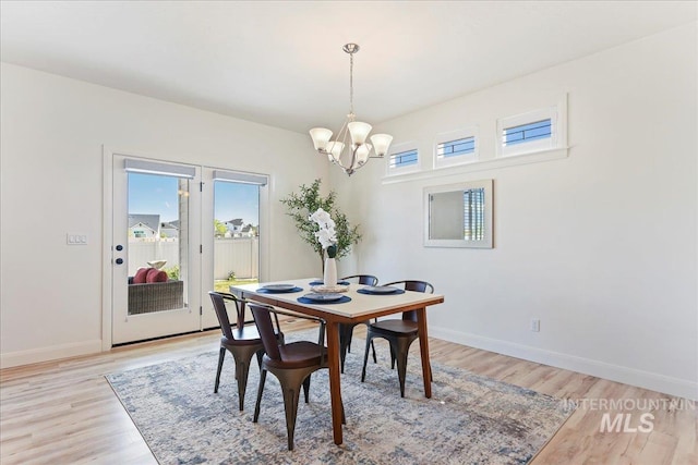 12740 S Alzano Way, Nampa, ID 83686 - dining area featuring a chandelier, light wood finished floors, and baseboards