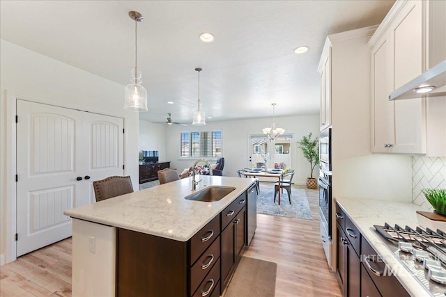 12740 S Alzano Way, Nampa, ID 83686 - kitchen with a sink, appliances with stainless steel finishes, dark brown cabinetry, white cabinets, and recessed lighting